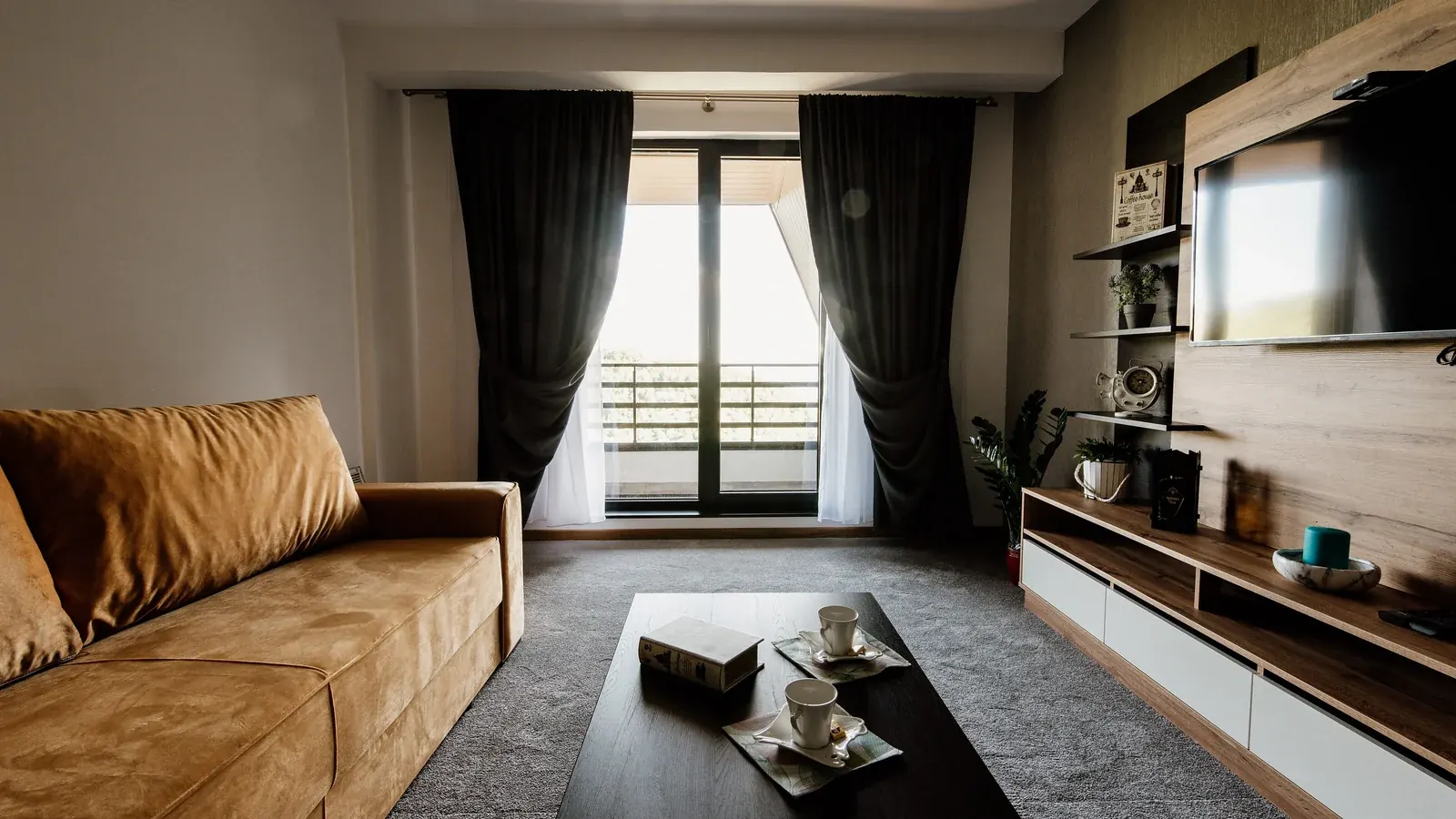 Modern living room with a sofa and a wall-mounted television