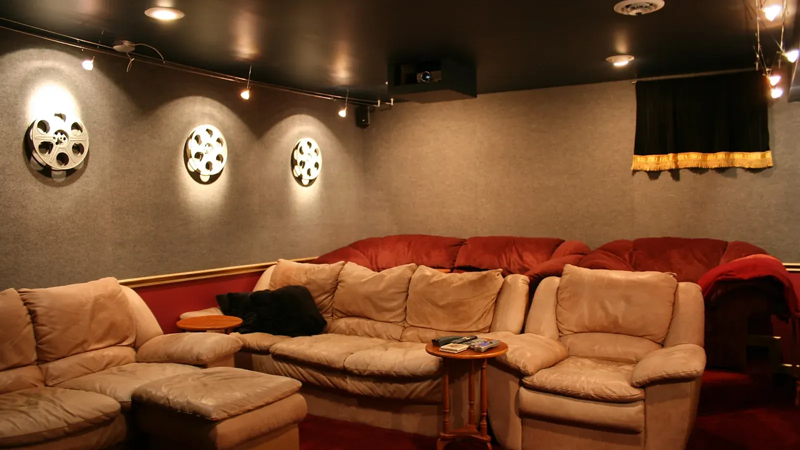 Home theater room with reclining seats and movie reel wall decor