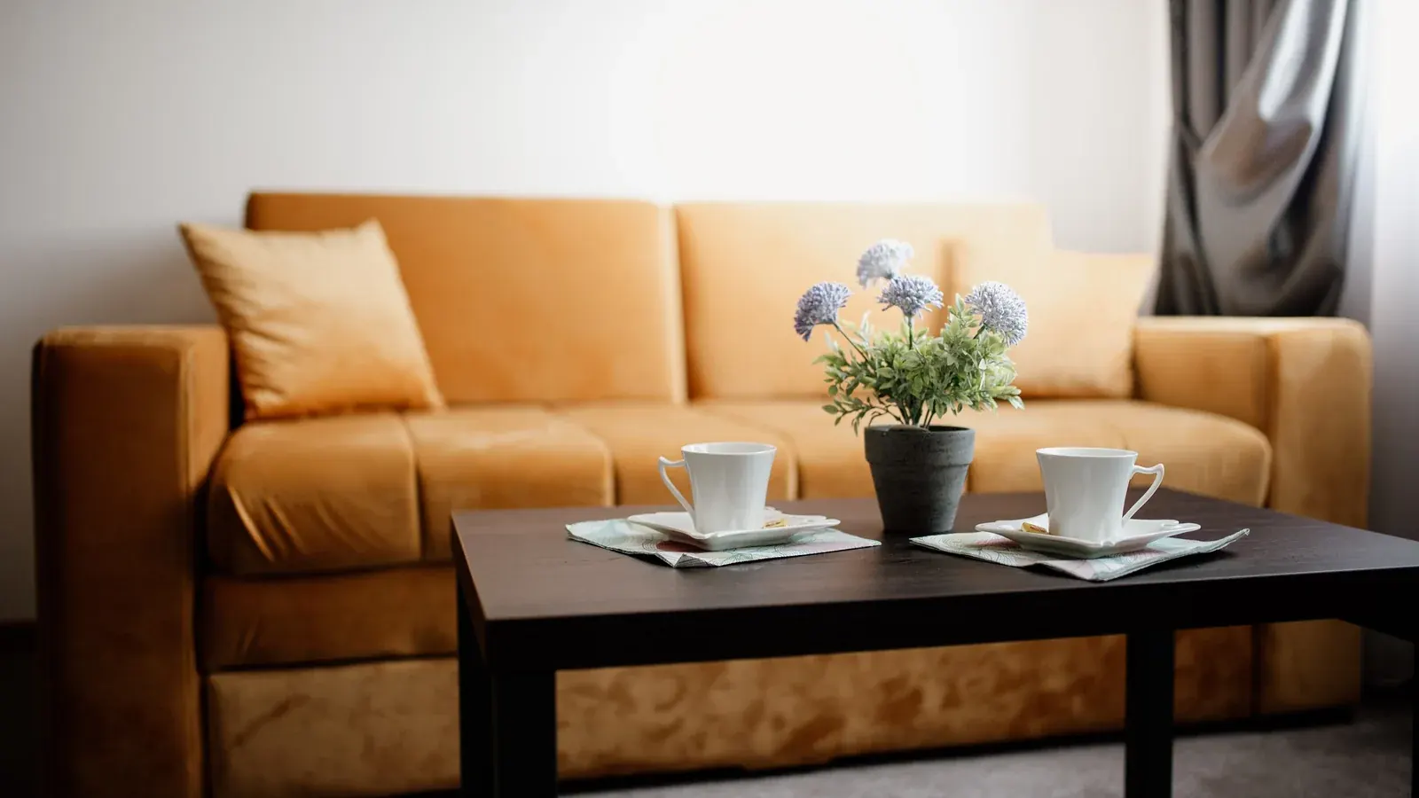 Cozy living room with a yellow sofa and a coffee table