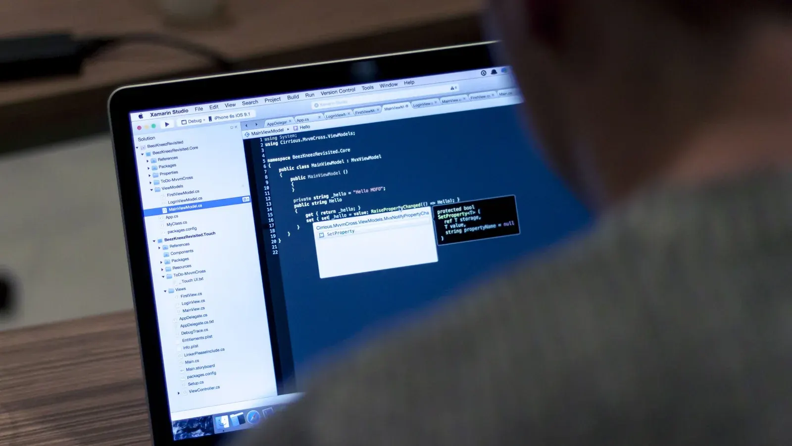 Person looking at code on a laptop screen while working
